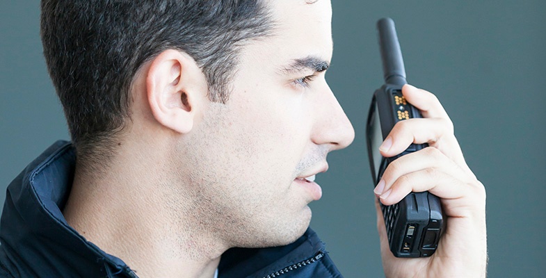 Man listens uses TH9 TETRA radio